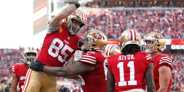 George Kittle #85 of the San Francisco 49ers celebrates a touchdown during the third quarter in the game against the Washington Commanders at Levi's Stadium on December 24, 2022 in Santa Clara, California. 