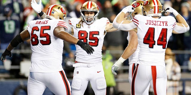 George Kittle #85 of the San Francisco 49ers celebrates with teammates after scoring a touchdown against the Seattle Seahawks during the third quarter of the game at Lumen Field on December 15, 2022 in Seattle, Washington. 