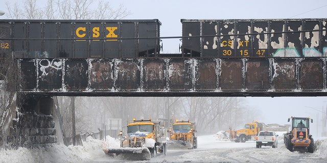 Plows work to clear ice and snow along the Lake Erie shoreline on December 24, 2022 in Hamburg, New York.