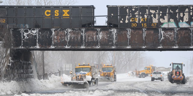 Plows work to clear ice and snow along the Lake Erie shoreline on December 24, 2022 in Hamburg, New York.