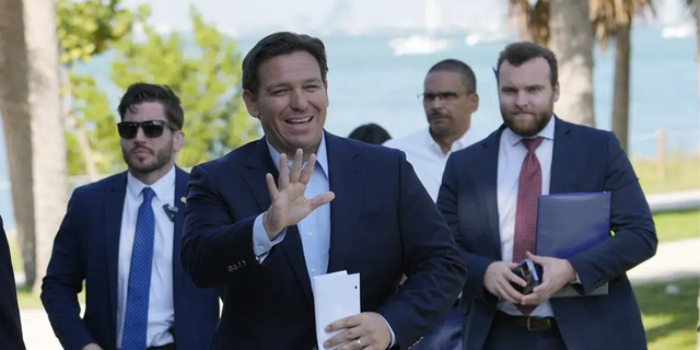 Florida Gov. Ron DeSantis waves as he arrives for a news conference at Bill Baggs Cape Florida State Park Dec. 1, 2022, in Key Biscayne, Fla. 