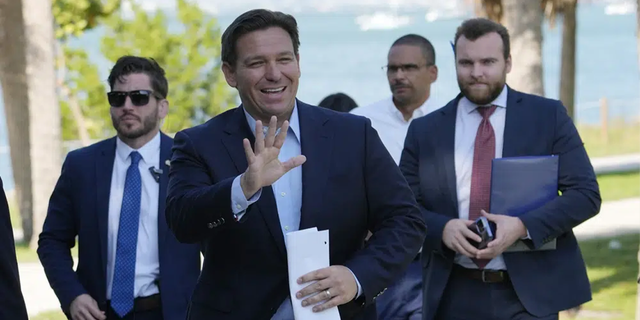 Florida Gov. Ron DeSantis waves as he arrives for a news conference at Bill Baggs Cape Florida State Park, Thursday, Dec. 1, 2022, on Key Biscayne, Fla. 