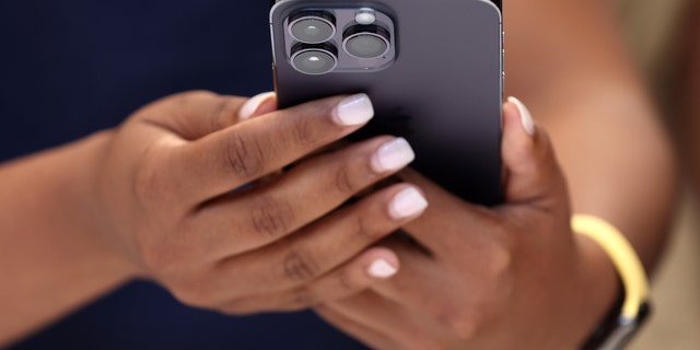 An attendee holds the new iPhone 14 Pro during a special Apple event on September 7, 2022 in Cupertino, California.