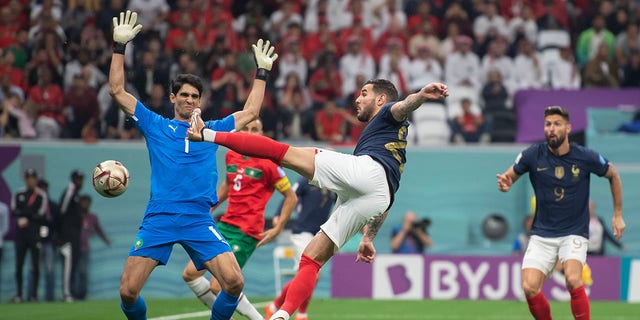 Theo Hernandez of France scores the opening goal past Yassine Bounou of Morocco during a FIFA World Cup Qatar 2022 semifinal match at Al Bayt Stadium Dec. 14, 2022, in Al Khor, Qatar.