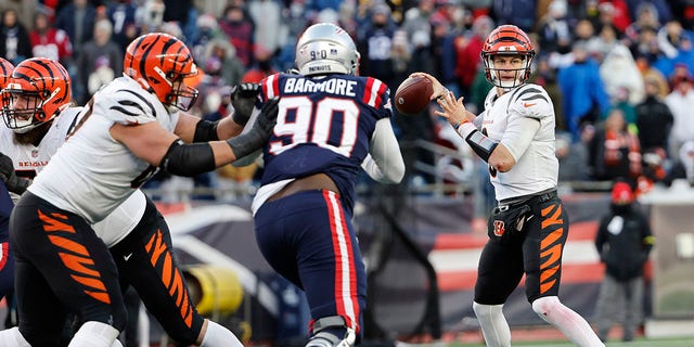 FOXBOROUGH, MASSACHUSETTS - DECEMBER 24: Joe Burrow #9 of the Cincinnati Bengals attempts a pass during the fourth quarter against the New England Patriots at Gillette Stadium on December 24, 2022 in Foxborough, Massachusetts.