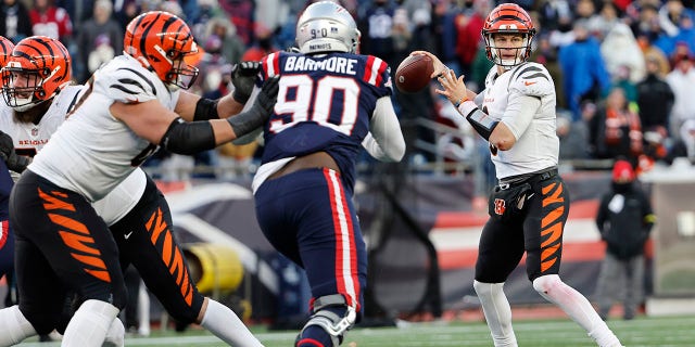 FOXBOROUGH, MASSACHUSETTS - DECEMBER 24: Joe Burrow #9 of the Cincinnati Bengals attempts a pass during the fourth quarter against the New England Patriots at Gillette Stadium on December 24, 2022 in Foxborough, Massachusetts.