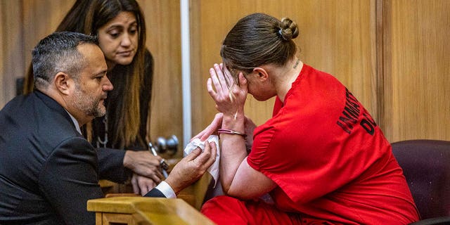 Defense attorneys Sabrina Puglisi and Frank Prieto talked to their client, OnlyFans model Courtney Clenney, as she reacts after Judge Laura Shearon Cruz’s decision to deny for her to get out of jail to await trial. She is accused of murdering her boyfriend Christian Obumseli on April 3, 200, in Miami. The hearing took place at the at the Richard E. Gerstein Justice Building, in Miami, on Dec. 8, 2022.