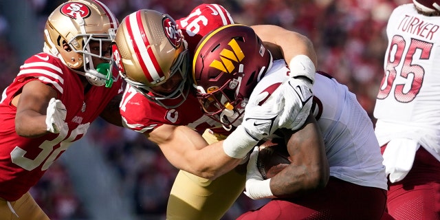 San Francisco 49ers defensive end Nick Bosa (97) tackles Washington Commanders running back Brian Robinson Jr. in the first half of an NFL football game, Saturday, Dec. 24, 2022, in Santa Clara, Calif. 