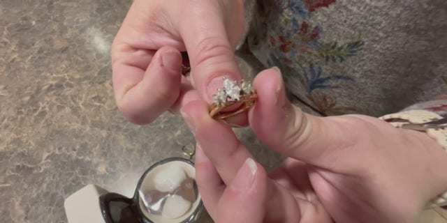 Shaina Day holds her engagement ring after it was missing in her in-laws' toilet for more than 20 years.