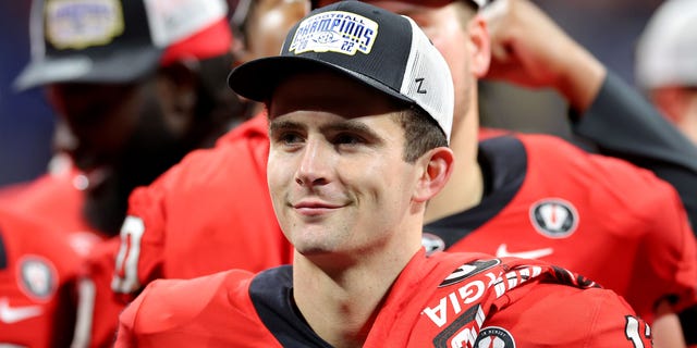 Stetson Bennett #13 of the Georgia Bulldogs celebrates after defeating the LSU Tigers in the SEC Championship game at Mercedes-Benz Stadium on December 03, 2022, in Atlanta, Georgia.