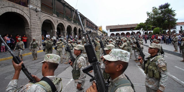 Soldiers stand in formation after arriving as reinforcements amid violent protests following the ousting and arrest of former President Pedro Castillo, in Ayacucho, Peru, December 15, 2022. REUTERS/Miguel Gutierrez Chero.