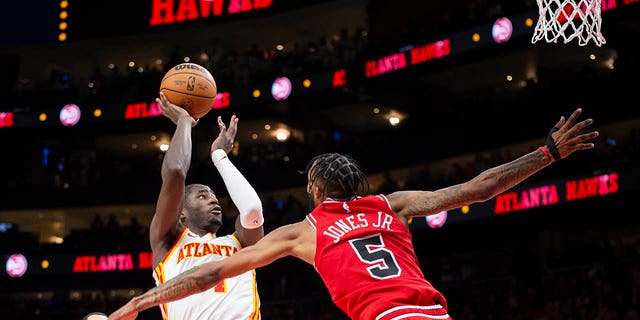 Atlanta Hawks forward AJ Griffin shoots a buzzer-beater over Chicago Bulls forward Derrick Jones Jr., Sunday, Dec.  11, 2022, in Atlanta.