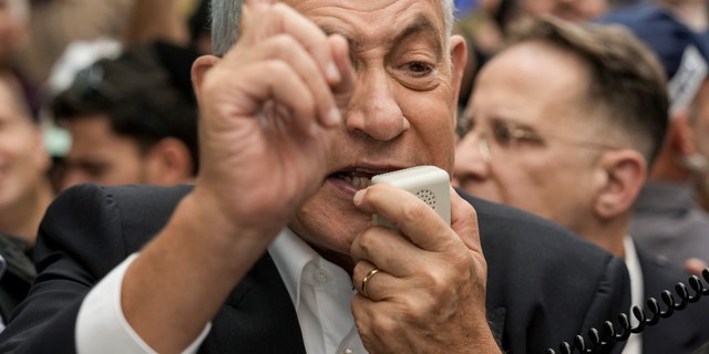 Likud party head and incoming Israeli Prime Minister Benjamin Netanyahu speaks to his supporters as he visits Hatikva Market in Tel Aviv, Israel, Friday, Oct. 28, 2022.