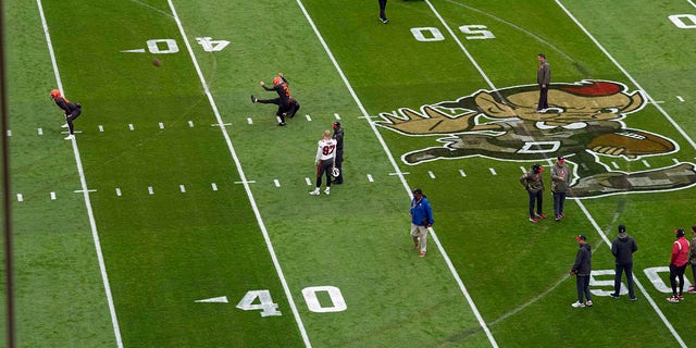 Tire tracks can be seen on the field at First Energy Stadium during team warm-ups before the game between the Cleveland Browns and Tampa Bay Buccaneers in Cleveland, Nov. 27, 2022. Earlier in the week, a man drove a pickup around the field and tore up the turf.