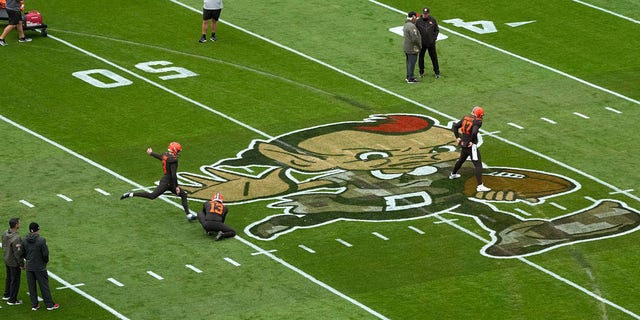 Tire tracks can be seen on the field at First Energy Stadium during team warm-ups before the game between the Cleveland Browns and Tampa Bay Buccaneers in Cleveland, Nov. 27, 2022. Earlier in the week, a man drove a pickup around the field and tore up the turf.