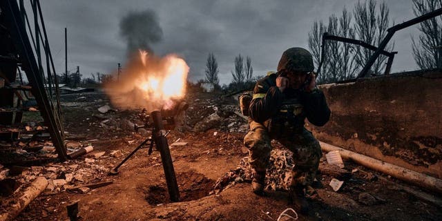 A Ukrainian soldier fires a mortar at Russian positions in Bakhmut, Donetsk region, Ukraine, Oct. 11, 2022.  