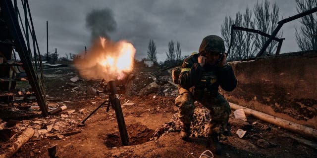 FILE - A Ukrainian soldier fires a mortar at Russian positions in Bakhmut, Donetsk region, Ukraine, Thursday, Nov. 10, 2022.  A top adviser to Ukraine's president has cited military chiefs as saying 10,000 to 13,000 Ukrainian soldiers have been killed in the country's nine-month struggle against Russia's invasion.