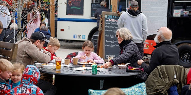 Residents at Reds Food Truck Corner in Southern Pines, North Carolina, having lunch while the power is out in the area on Monday, Dec. 5.