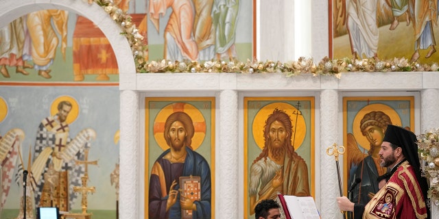 Bishop Apostolos of Medeia, right, participates in a service at St. Nicholas Greek Orthodox Church in New York City on Tuesday, Dec. 6, 2022.