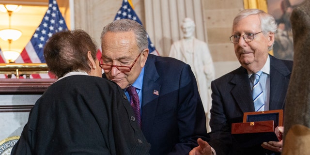 Gladys Sicknick, left, mother of slain U.S. Capitol Police Officer Brian Sicknick, is greeted by Senate Majority Leader Chuck Schumer of New York, with Senate Minority Leader Mitch McConnell of Kentuckey. The members of the Sicknick family declined to shake hands with McConnell and House Minority Leader Kevin McCarthy of California. 