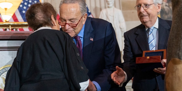 Gladys Sicknick, left, mother of slain U.S. Capitol Police Officer Brian Sicknick, is greeted by Senate Majority Leader Chuck Schumer of New York, with Senate Minority Leader Mitch McConnell of Kentuckey. The members of the Sicknick family declined to shake hands with McConnell and House Minority Leader Kevin McCarthy of California. 