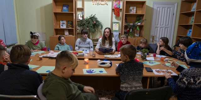 Children traumatized by the war in Ukraine draw in the Center for Social and Psychological Rehabilitation in Boyarka near Kyiv, Ukraine, on Wednesday, Dec. 7, 2022.