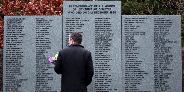 A man looks at the main memorial stone in memory of the victims of the bombing of Pan Am flight 103, in the garden of remembrance near Lockerbie, Scotland on Friday Dec. 21, 2018. 