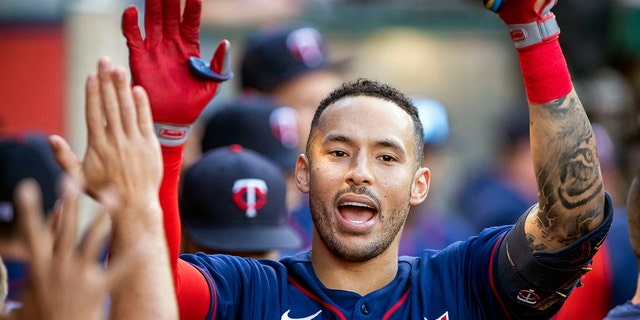 FILE - Minnesota Twins' Carlos Correa is congratulated after hitting a solo home in Anaheim, Calif., Saturday, Aug. 13, 2022. 