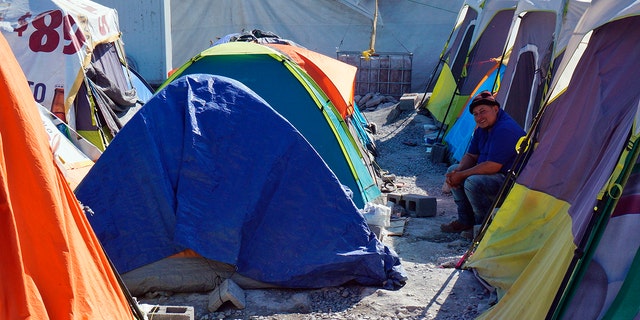A migrant sits by his tent inside the Senda de Vida 2 shelter in Reynosa, Mexico, Thursday, Dec. 15, 2022. 