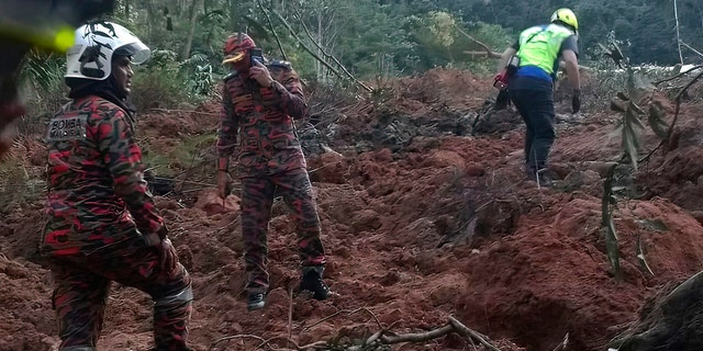 In this photo posted by Korporat JBPM, rescuers work during a rescue and evacuation operation following a landslide at a campsite in Batang Kali, Selangor state, on the outskirts of Kuala Lumpur, Malaysia, Dec. 16, 2022.