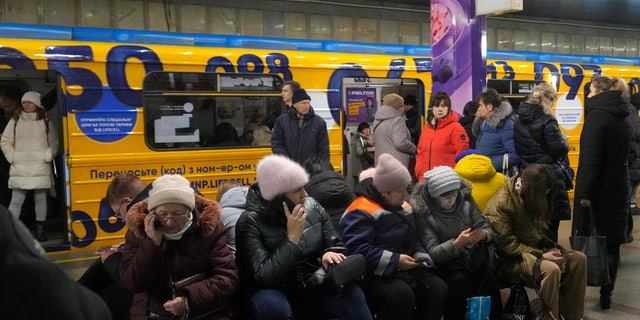 People rest in the subway station, which was used as a bomb shelter during a missile attack in Kiev, Ukraine on Friday, December 16, 2022. 