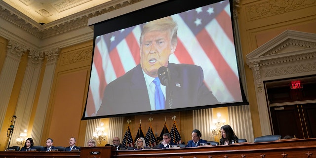 Video of former President Donald Trump appears on screens as the House Select Committee investigating the January 6 attack on the U.S. Capitol holds its final session on Monday, December 19, 2022, on Capitol Hill in Washington. It will be displayed in.
