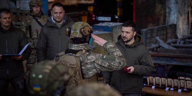 In this photo provided by the Ukrainian Presidential Press Office, Ukrainian President Volodymyr Zelenskyy, right, awards a serviceman at the site of the heaviest battles with the Russian invaders in Bakhmut, Ukraine, Dec. 20, 2022.