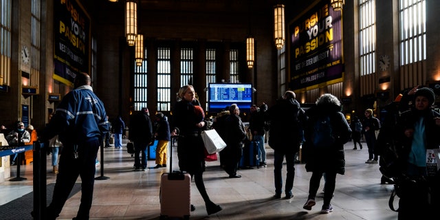 Travelers move through Amtrak's 30th Street Station in Philadelphia on Wednesday, Dec. 21, 2022.