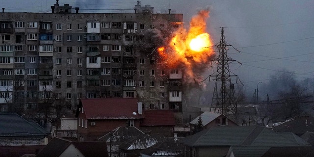 An explosion erupts from an apartment building after a Russian army tank fired on it in Mariupol, Ukraine, March 11, 2022. (AP Photo/Evgeniy Maloletka, File)