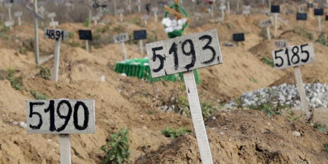 This Nov. 16, 2022 image from video shows some of the new graves which have been dug since the Russian siege began, at the Staryi Krym Cemetery on the outskirts of the occupied Ukrainian city of Mariupol. 