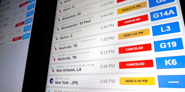 American Airlines flight information screens display flight information, including canceled and delayed flights, at O'Hare International Airport in Chicago, Thursday, Dec.  22, 2022.