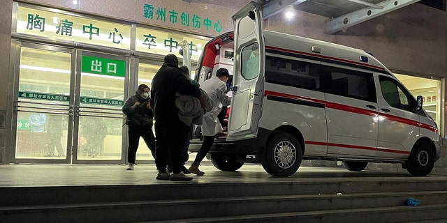 An ambulance prepares to transfer a patient in critical care to other hospitals due to overcapacity at the emergency department of the Langfang No. 4 People's Hospital in Bazhou city in northern China's Hebei province on Thursday, Dec. 22, 2022. 