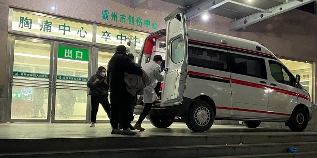 An ambulance prepares to transfer a patient in critical care to other hospitals due to overcapacity at the emergency department of the Langfang No. 4 People's Hospital in Bazhou city in northern China's Hebei province on Thursday, Dec. 22, 2022. 