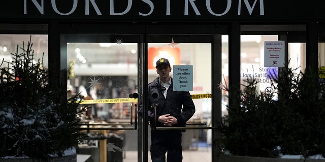 An officer stands inside Nordstrom at Mall of America after a shooting, Friday, Dec. 23, 2022, in Bloomington, Minn. 