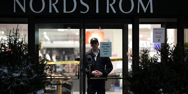 An officer stands inside Nordstrom at Mall of America after a shooting, Friday, Dec. 23, 2022, in Bloomington, Minnesota.