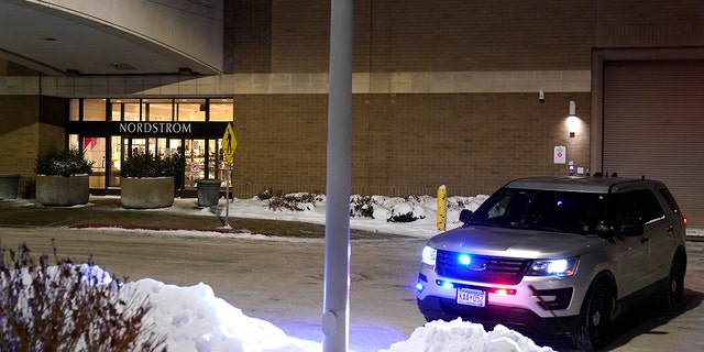A police car parked outside the Nordstrom at the Mall of America after a shooting in Bloomington, Minnesota, Friday, Dec. 23, 2022. 
