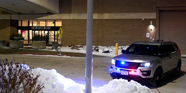 A police car sits parked outside Nordstrom at Mall of America after a shooting Friday, Dec. 23, 2022, in Bloomington, Minn.