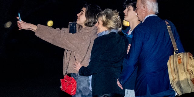 President Joe Biden, first lady Jill Biden, and their grandchildren Natalie and Robert, take a selfie before boarding Marine One on the South Lawn of the White House in Washington, Tuesday, Dec. 27, 2022, for a short trip to Andrews Air Force Base, Md., and then on to St. Croix, U.S. Virgin Islands. 