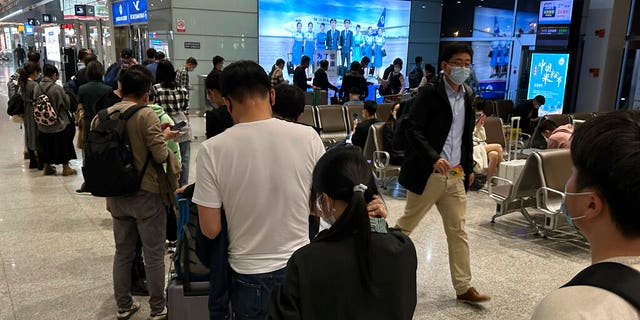 Passengers prepare to board a flight at the airport in north-central China's Jiangxi province.