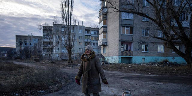 Svetlana, 57, carries a cart with buckets full of water, as they have lived without running water and electricity for more than 6 months in Stary Saltyv, Kharkiv region, Ukraine, Thursday, December 29, 2022. 