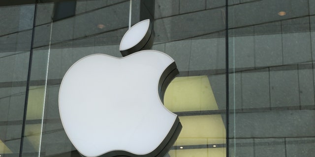 The logo of Apple Inc, the Cupertino, California-based American multinational technology company that designs, develops and sells consumer electronics, computer software and online services, appears in a pedestrian zone in Munich. 