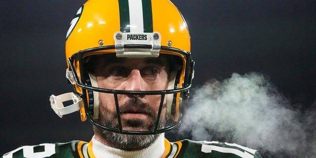 Green Bay Packers quarterback Aaron Rodgers (12) takes a breath while warming up before an NFL football game against the Los Angeles Rams in Green Bay, Wis. Monday, Dec. 19, 2022.