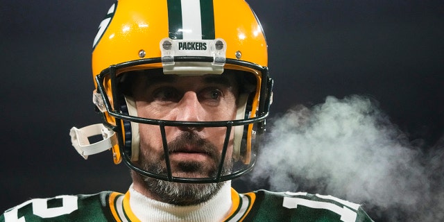 Green Bay Packers quarterback Aaron Rodgers (12) breaths out as he warms up before an NFL football game against the Los Angeles Rams in Green Bay, Wis. Monday, Dec. 19, 2022.