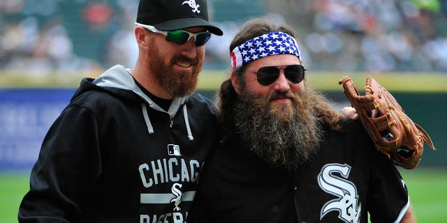 "Duck Dynasty" star Willie Robertson, right, talks with Adam LaRoche, #25 of the Chicago White Sox, after throwing out the ceremonial first pitch before theme between the Chicago White Sox and the Seattle Mariners on Aug. 30, 2015 at U.S. Cellular Field in Chicago.